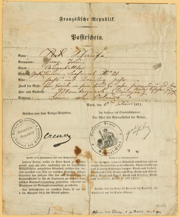 Ein altes, gelbliches Dokument mit einem kreisförmigen, schwarz umrandeten Stempel, wahrscheinlich ein Brief von der deutschen Regierung, geschrieben in schwarzer Tinte.