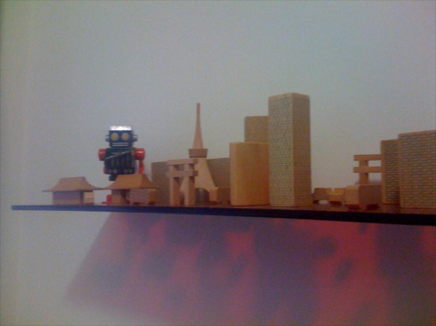 Das Innere eines McDonald's-Restaurants mit einem sichtbaren Schild, Metallstangen mit roten Bändern und ein paar Menschen im Vordergrund, mit Hintergrundelementen teilweise sichtbar.