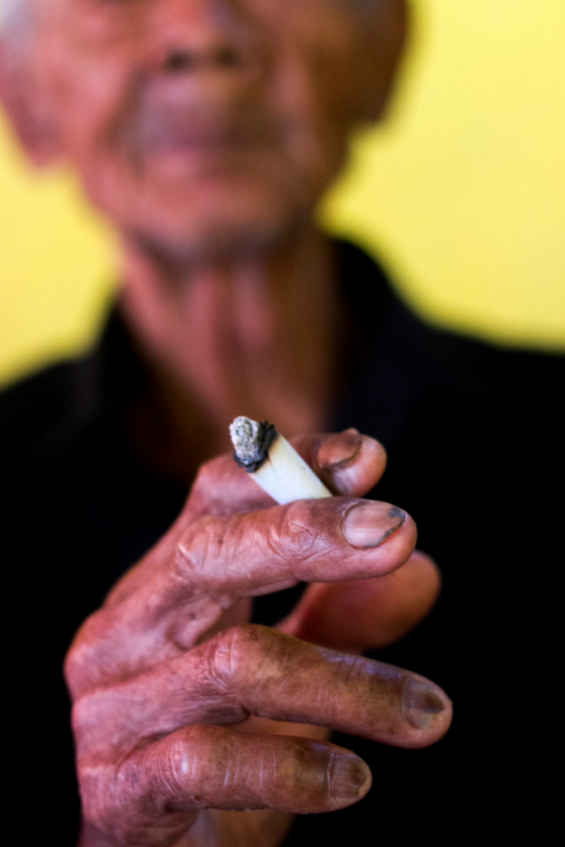 Eine Person mit einer Zigarette in der Hand.